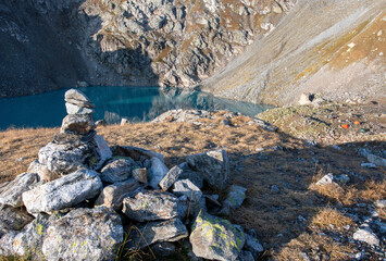 Stone pyramid (cairn) on Sophia lake. Arkhyz, Caucasus, Russia.