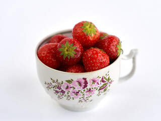 Full cup of ripe fresh strawberries on white background