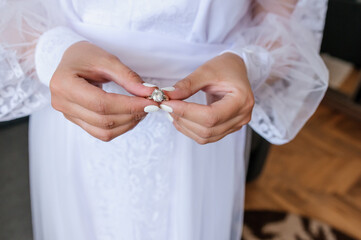 Gold ring with a stone in the hands of the bride