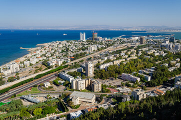 Mountain view of the city and the sea coast on a bright sunny day. Haifa downtown, port and the Mediterranean Sea, Israel.