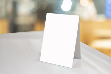 Mock up Label the blank menu frame or or booklets with white sheets paper acrylic tent card on...