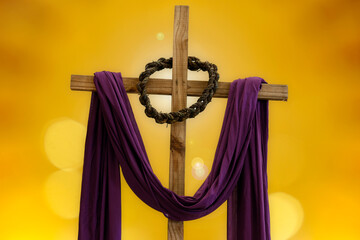 wooden cross, crown of thorns and purple fabric - lent theme