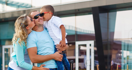 happy family hugging at airport