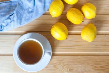 A cup of fresh tea with lemons. An invigorating drink