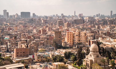 Panoramic aerial view of downtown Cairo with buildings and Cairo Tower in the background seen from Saladin Fortress on a foggy day