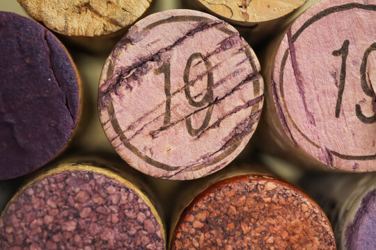 Makro closeup of pile isolated vintage red wine corks with number 19 (focus on center)