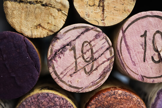 Makro closeup of pile isolated vintage red wine corks with number 19 (focus on center)
