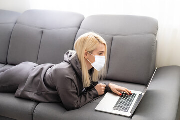 Coronavirus or Covid-19 concept. Business woman working from home wearing protective mask. Business woman in quarantine for coronavirus wearing protective mask. Working from home