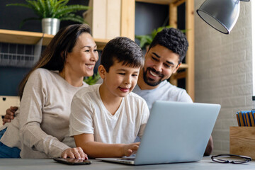Mother and Father Helping Child With School online homework