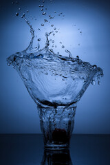 A glass of water with splash against white background