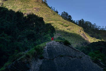 Boy at the peak of the rock