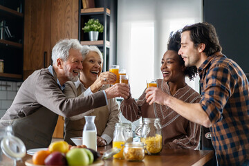 Multi Generation Family Enjoying Meal At Home Together