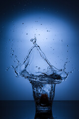 A glass of water with splash against white background
