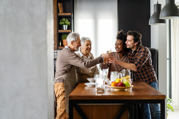 Multi Generation Family Enjoying Meal At Home Together