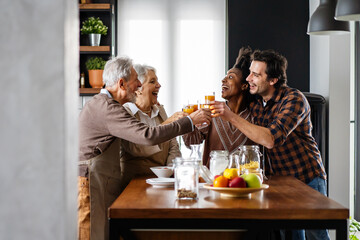 Multi Generation Family Enjoying Meal At Home Together