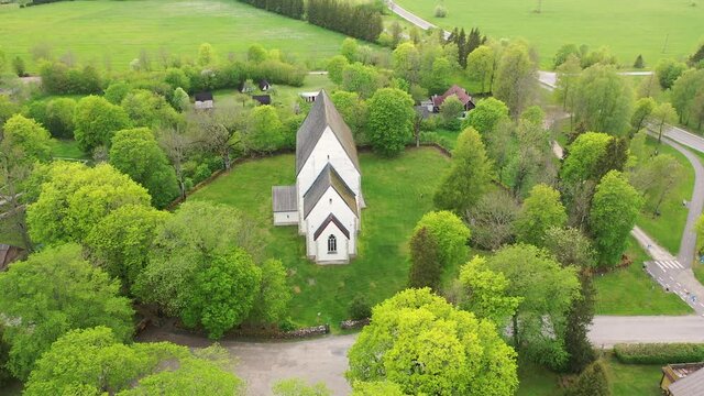 Muhu Island in the Baltic sea, Saare County, Estonia. Beautiful 4K panoramic aerial video from flying drone to Muhu St. Catherine's Church, (Muhu Katariina kirik) on a sunny summer day. (Series)