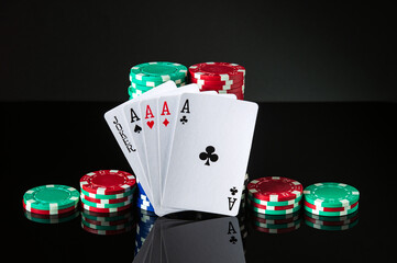 Obraz premium Poker cards with five of a kind the highest combination. Close-up of playing cards and chips in poker club. Free advertising space