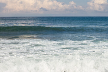 Fototapeta na wymiar Seascape. Blue Sea, White Waves, Blue Sky.