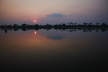 Sunset, sunrise with clouds, light rays on field at countryside Thailand