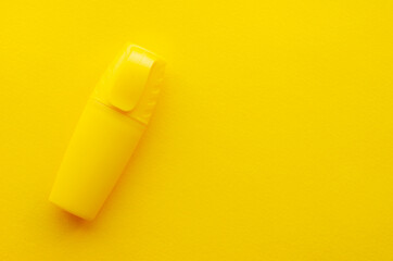 Yellow marker on yellow background, top view, copy space. School, office supplies - marker. Marker to highlight texton yellow background, top view, copy space. Marker for highlighting text.
