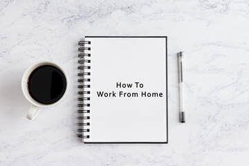 Notebook on desk written how to work from home