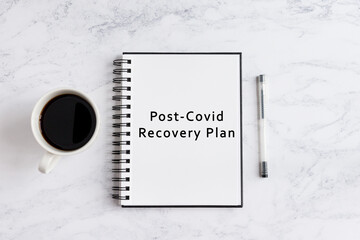 Notebook on desk written post-covid recovery plan