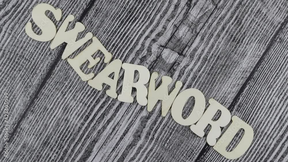 Poster swearword - concept design template on rustic wooden background with wavy line of alphabet letters a