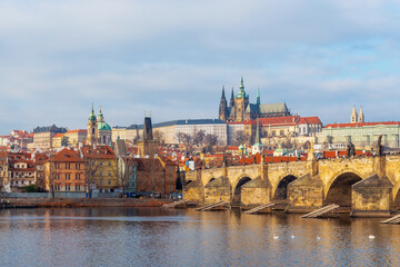 Cityscape of Prague at sunrise with view over Mala Strana district with Charles Bridge, Cathedral and Hradcany Castle, Czech Republic.