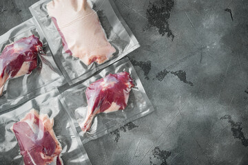 Duck meat vacuum packed, on gray stone background, top view flat lay, with copyspace  and space for text