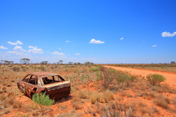 Australian outback wilderness and remoteness and broken car by the road