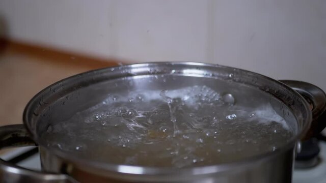 Macaroni Falling in a Pot of Boiling Water. Boil Pasta. Bubbles, Boiling Water