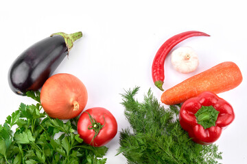 Food background. Seasonal vegetables and greens on a white table. Top view, flat lay