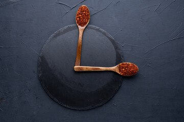 Indian spices selection in wooden spoons over dark cement background. Food or spicy cooking concept, Healthy eating Background