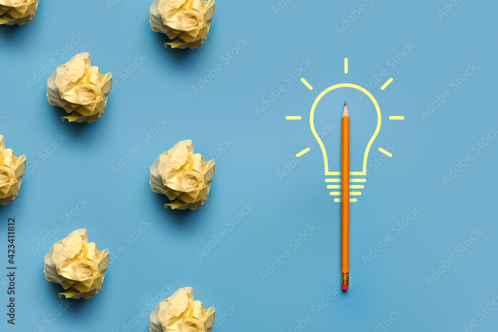 Poster a burning light bulb and crumpled paper next to it. a symbol of a difficult task and the emergence o