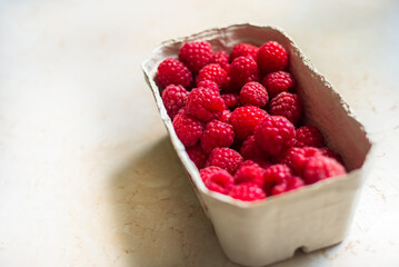 a basket of fresh juicy red raspberries