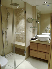 Modern design interiors inside bathroom with bathtub double vanity sink, glas shower, mirror,...