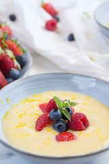 custard cream with berries close up