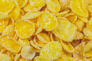 Yellow Cornflakes close up photo, Food texture background, top view. Macro shot. Perfect breakfast.
