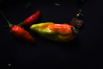 Chili peppers on black background. kitchen photography concept.