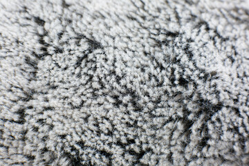 Grey cotton towel or carpet.fluffy texture background. Close up, macro photo. Soft focus image.