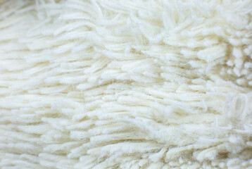 White cotton towel or carpet.fluffy texture background. Close up, macro photo. Soft focus image.