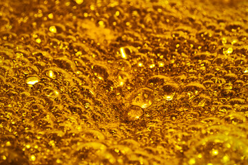 Golden foam. Background and texture concept. Close up of bubbling golden foam. Foam texture as background