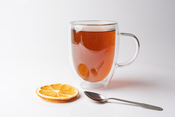 glass thermo mug with black tea on a white background