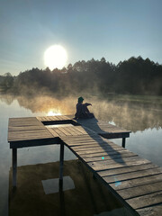 person sitting on a pier