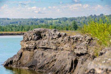 cape of slags left after mechanical cleaning of the tailing dump. The section shows a layered structure of deposits