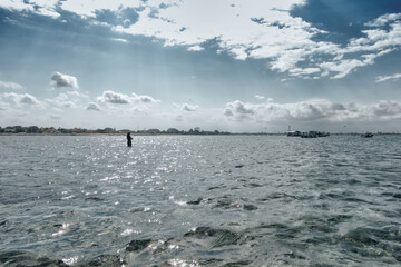 The fishing scene is fishing in the middle of the beach under the beautiful afternoon sun and blue sky