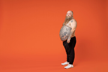 Full length side profile view fat caucasian pudge obese chubby overweight tattooed bearded man 30s...