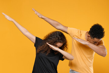 Young couple two friends together family african man woman 20s in black t-shirt doing dab hip hop...