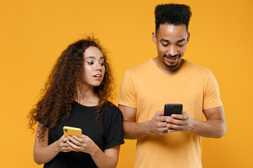 Young couple two friends together family african jelaous woman man in black t-shirt holding using...