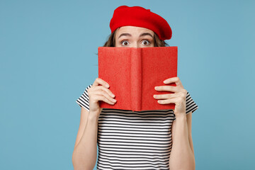 Young smart student woman 20s with short hairdo wear french beret red hat striped t-shirt hiding...
